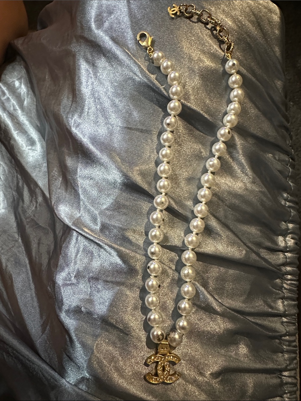 Damaged from velour bagCHANEL White Pearl Necklace with Gold Crystal CC Pendant.